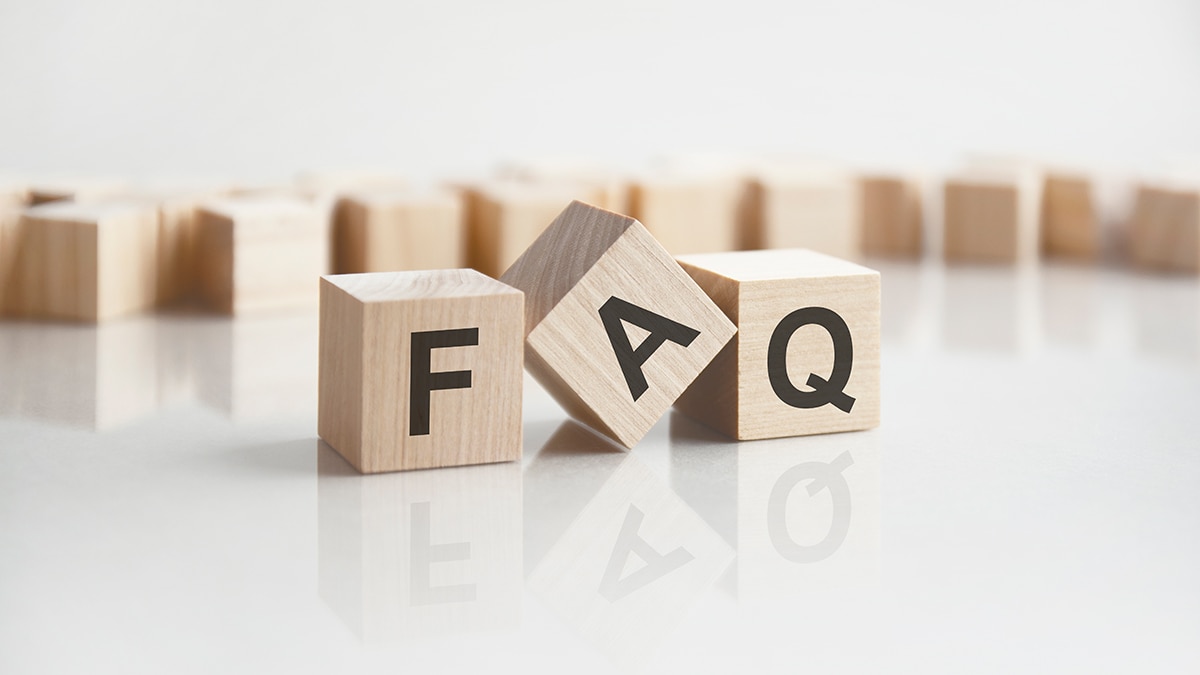 three wooden blocks with black letters spelling out "FAQ"